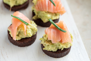 Avocado paste with salmon on wholemeal bread