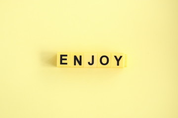 Enjoy concept. The inscription on a yellow background.