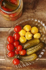 Salted tomatoes cucumbers and squash on the table