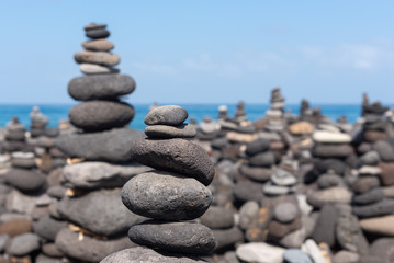 Fototapeta na wymiar Stone cairns on Puerto de la Cruz coast, Tenerife island, Spain