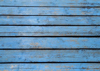 The wooden floor is blue. The boards are positioned horizontally and are used as pier flooring or floor boards. Taken from above. The concept of using natural, natural materials in construction, desig