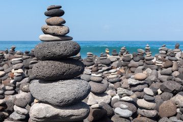 Stone cairns on Puerto de la Cruz coast, Tenerife island, Spain