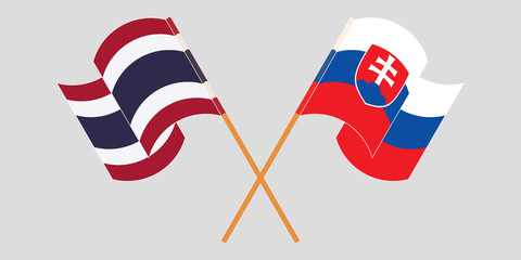 Crossed and waving flags of Slovakia and Thailand