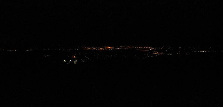 Distant View Of City Electric Lights At Night