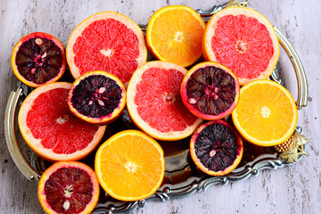 Circles of orange, grapefruit and red orange on a wooden background. Vitamin C.