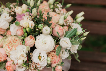large flower arrangement in a big white hat box was created by a florist for a wedding gift. White Freesia ,  Ranunculus asiaticus, eustoma flowers, roses and eucalyptus in a flowers box