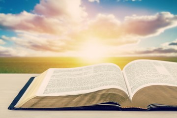Holy Bible book on a wooden desk