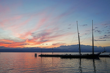 Fototapeta na wymiar Sunset over the harbor on the lake Geneva, Evian les Bains, France