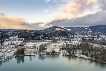 Fototapeta premium Aerial drone shot view of Leopoldskroner lake southwest of outskirts of Salzburg during winter