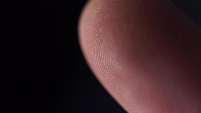 EXTREME CLOSE UP MACRO: Detail of fingerprint on Caucasian index finger. White person's skin pattern and texture on fingertips. White man's finger prints