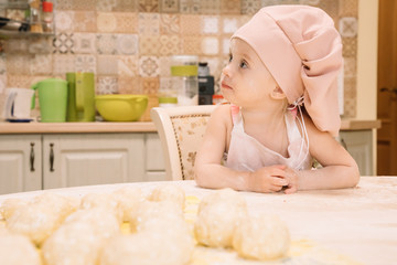 Little girl cooks at home in the kitchen