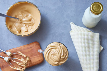 Dalgona coffee trend korean drink latte espresso on a gray concrete background. Top view, flat lay