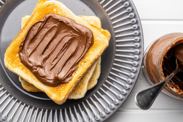 Toast bread with hazelnut spread. Sweet chocolate cream.