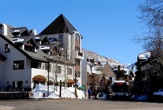 The Town Of Vail, Colorado With Quaint Shops And Businesses In A Resort Setting With Beautiful Mountain And Forest Views All Around.  