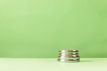 Professional dumbbell weight plates for fitness and on a green background. Fitness healthy and sport concept