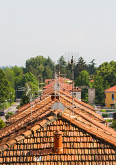 roofs of old houses with red tiles in a row