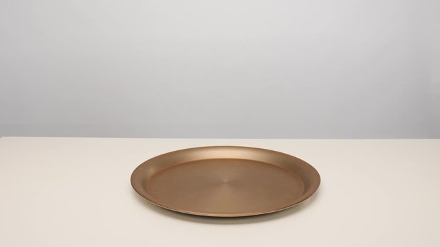Male waiter opening empty tray on white table