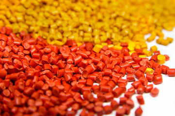 Colorful plastic polymer granules isolated on white 