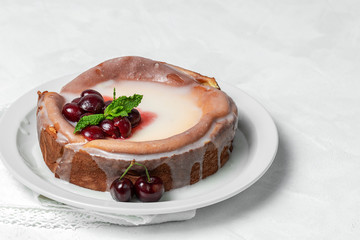 Homemade cheesecake with cherries and mint on white background