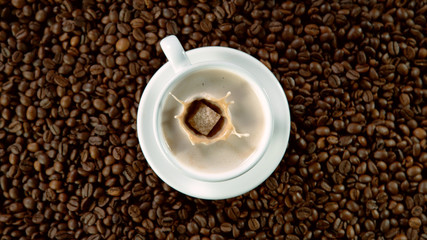 Falling sugar canes into cup of hot coffee