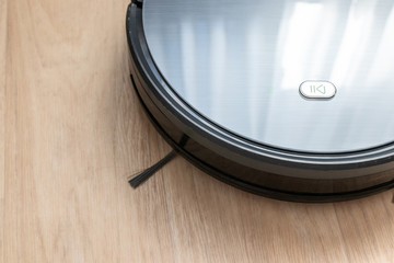 Vacuum cleaner robot clean dusty floor cleaning in the bedroom. Smart home, wireless technology concept