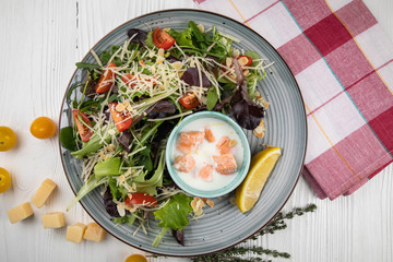 Italian cuisine. Salad with vegetables, sauce and seafood on a white background