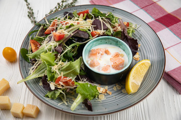 Italian cuisine. Salad with vegetables, sauce and seafood on a white background