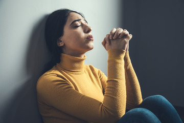 praying woman sitting in ground