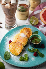 Fresh cheesecakes with berries with honey and hot chocolate