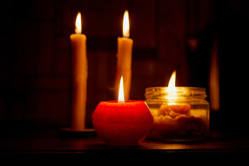 Candle on dark background. Candle in low key. Candle flame at night closeup