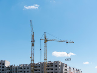 Fototapeta na wymiar Construction site with two cranes against the sky