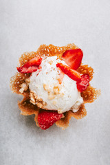 Vanilla Ice Cream Scoops with strawberry pieces into the waffle basket, easy dessert at home