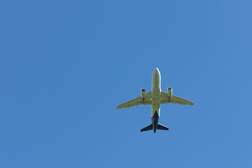 Airplane flies against a background of blue sky