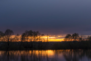 Summer evening and sunset on a forest lake
