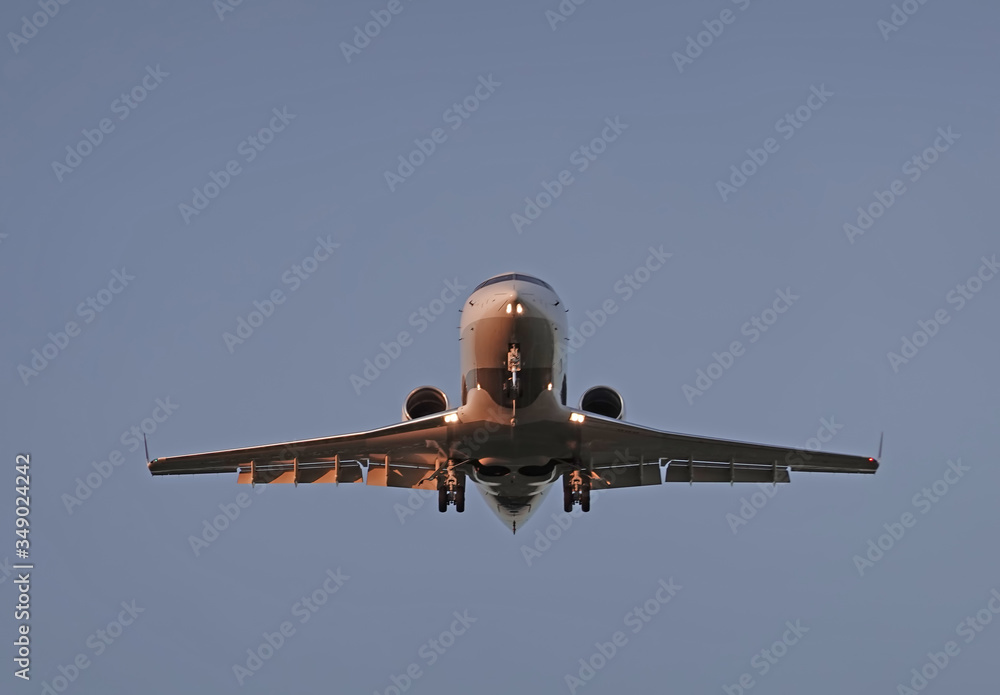 Wall mural airplane flies against a background of blue sky