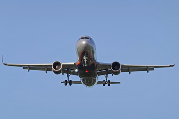 Airplane flies against a background of blue sky