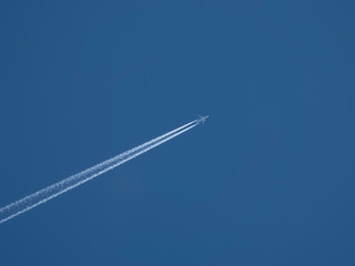 Airplane flies against a background of blue sky