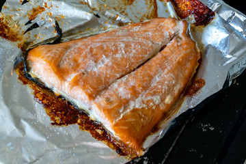 Trout baked in foil on an old baking sheet. Baking at home