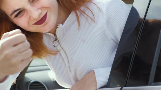 Closeup portrait of pissed off displeased angry aggressive woman driving a car backwards shouting at someone. Negative human expression and road rage consept.