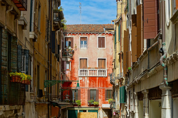 Fototapeta na wymiar Tourist view of Venice. Channels with reflections. Street lights and colorful houses in the bright sun. Comfort and tranquility.