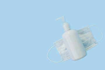 Sanitizer gel or antibacterial soap and face mask for coronavirus preventive measure, top view
