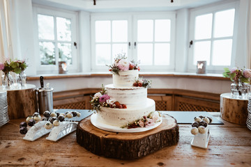 photo of wedding cake with flowers on a table
