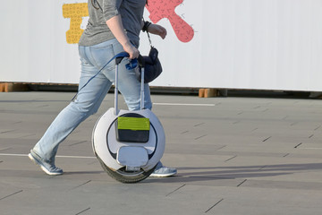 people go with an electric monowheel to the shopping center © justoomm