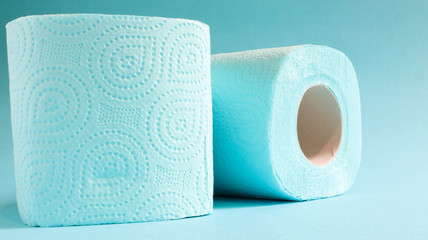 Blue roll of modern toilet paper on a blue background. A paper product on a cardboard sleeve, used for sanitary purposes from cellulose with cutouts for easy tearing. Embossed drawing