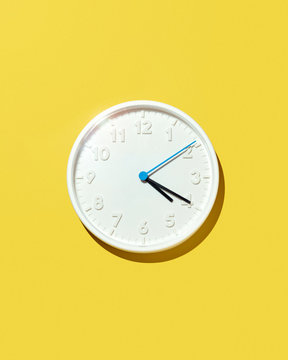 White Four-Twenty Clock Isolated on Yellow Background