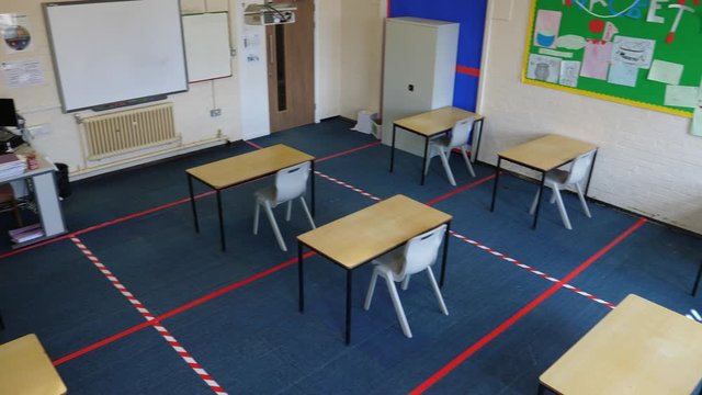 4K: Empty School Classroom with Tape on the floor between desks for Social Distancing to help prevent the spread of COVID-19 Coronavirus. Looking down. Stock Video Clip Footage