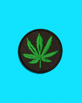 Cannabis Leaf Black Patch Isolated on Blue Background