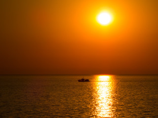 Ship at sea in the sunset