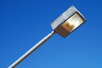 square retro design from the seventies street lamp against blue sky