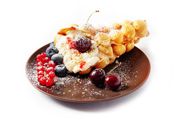 Delicious sweet bubble waffles with berry on a white isolated background